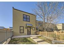 Inviting exterior of a modern home with a well-maintained lawn and charming wooden fence at 3215 Foundry Pl # 106N, Boulder, CO 80301