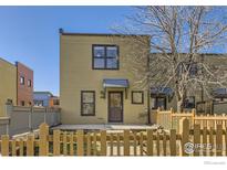 Charming home exterior with a quaint wooden fence and well-kept front yard at 3215 Foundry Pl # 106N, Boulder, CO 80301