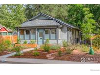 Charming home featuring a well-maintained landscaped front yard with stone path leading to the front door at 42 Marshall Pl, Longmont, CO 80504