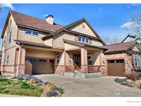 Charming two-story home with a two-car garage, stone accents, and covered porch, perfect for curb appeal at 4236 Frederick Cir, Longmont, CO 80503