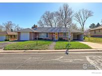 Charming single-story home with a brick facade, attached carport, and well-maintained front yard at 4580 Balsam St, Wheat Ridge, CO 80033