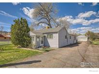 Charming single-story home featuring a well-manicured lawn and a detached garage at 5335 Allison St, Arvada, CO 80002