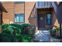 Inviting front entrance features a private balcony, well-kept shrubs, and a welcoming wreath on the front door at 6221 Willow Ln, Boulder, CO 80301
