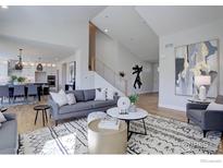 Bright living room featuring modern furnishings and decor and an open floor plan at 1041 Turnberry Cir, Louisville, CO 80027