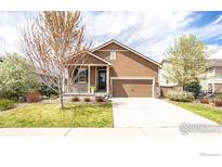 Charming single-Gathering home featuring a well-manicured front yard and a welcoming covered porch at 1358 14Th Ave, Longmont, CO 80501