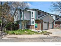 Inviting home with a well-manicured lawn, a two-car garage, and tasteful exterior paint at 1435 Agape Way, Lafayette, CO 80026