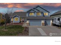 Charming two-story home featuring a well-maintained lawn, a three-car garage, and inviting curb appeal at 1441 Auburn Ct, Longmont, CO 80503