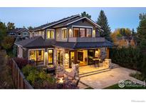 Expansive back patio with flagstone, fire pit, dining area, and inviting outdoor living spaces at 1525 Jennine Pl, Boulder, CO 80304
