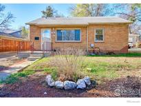 Charming brick home featuring a well-maintained front yard with a cozy and inviting facade at 1709 9Th Ave, Longmont, CO 80501