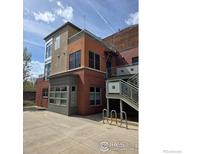 Modern multi-story building with brick and neutral tone accents and private outdoor stairway at 2336 Spruce St # 5, Boulder, CO 80302