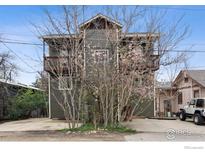 Charming two-story home featuring a wood exterior, a balcony, and a driveway at 2651 9Th St, Boulder, CO 80304