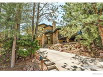 Inviting exterior view of a stucco home featuring a stone facade, wood accents, and professional landscaping at 2790 Juilliard St, Boulder, CO 80305