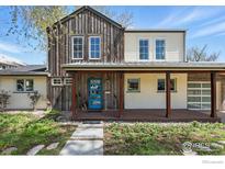Charming home with a covered porch, mixed siding, blue door and well-kept landscaping at 2970 21St St, Boulder, CO 80304