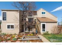 Charming multi-story condo featuring a quaint garden, welcoming curb appeal, and inviting outdoor space at 3135 Redstone Ln # E5, Boulder, CO 80305