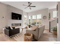 Bright living room features a tiled fireplace, sleek fan, and abundant natural light at 352 Superior Dr, Superior, CO 80027