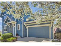 Charming two-story home with a two-car garage and beautiful flowering tree in the front yard at 3752 Red Deer Trl, Broomfield, CO 80020
