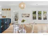 Dining room featuring modern white chairs, a white table, and custom built-in blue cabinets at 563 Arapahoe Ave, Boulder, CO 80302