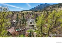 Beautiful two story home surrounded by trees and landscaping with a mountain view at 563 Arapahoe Ave, Boulder, CO 80302