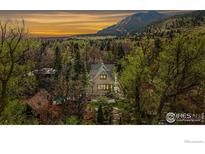Charming two-story home nestled in a lush landscape, with mountain views at sunset at 563 Arapahoe Ave, Boulder, CO 80302