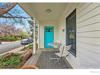 Inviting covered front porch featuring seating and a vibrant blue door adding curb appeal to this home at 644 Dewey Ave, Boulder, CO 80304