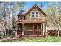 Charming two-story home featuring a cozy front porch and well-maintained landscaping at 700 Atwood St, Longmont, CO 80501