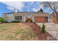Charming single-story home boasting modern upgrades including a stylish wood garage door and pergola at 7102 S Harrison Ct, Centennial, CO 80122