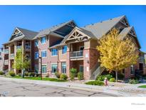 Attractive condo building features colorful Autumn foliage, manicured landscaping and welcoming entrances at 804 Summer Hawk Dr # 8105, Longmont, CO 80504