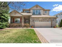 Charming two-story home with brick facade, covered porch and well-manicured lawn at 9506 Yukon St, Westminster, CO 80021