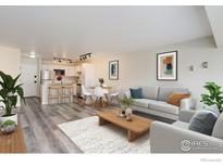 Open concept living room with modern decor, adjoining kitchen, and dining space, ideal for entertaining and comfortable living at 1121 Albion St # 402, Denver, CO 80220
