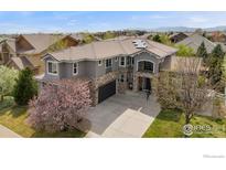 Beautiful two-story home boasting stone accents, tile roof, mature trees, and mountain views at 14295 Lipan St, Westminster, CO 80023