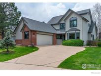 Charming two-story home with brick accents, mature trees and attached two-car garage at 1523 Lodge Ln, Boulder, CO 80303