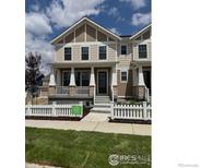 Charming two-story home with a welcoming front porch and well-manicured lawn at 193 Liberty St, Erie, CO 80516