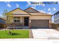 Charming single-Gathering home with a welcoming front porch and an attached two-car garage and manicured front lawn at 2218 Crosswind St, Fort Lupton, CO 80621