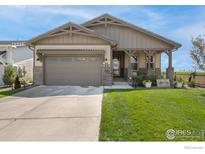 Charming single-Gathering home with a well-maintained lawn and attached two-car garage at 3304 Heron Lakes Pkwy, Berthoud, CO 80513