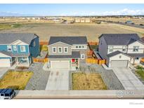 Aerial view of a suburban home with a fenced backyard and a green space nearby at 6163 Easton Cir, Frederick, CO 80504
