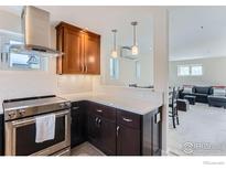 Well-equipped kitchen with stainless steel appliances and granite countertops at 620 Pearl St # E, Boulder, CO 80302