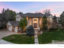 Stunning two-story home with stone accents, mature trees, and a well-manicured lawn at 787 Niwot Ridge Ln, Lafayette, CO 80026