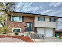 Inviting two-story home features a brick facade, black shutters, and a well-maintained front yard at 8351 Ralph Ln, Denver, CO 80221
