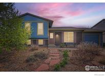 Charming home with a manicured front yard and stone walkway at 1011 Glenwood Dr, Lafayette, CO 80026