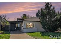 Charming home with well-maintained lawn and a covered carport at 1580 S Krameria St, Denver, CO 80224