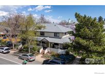 Charming two-story home featuring a well-maintained front yard and inviting entrance with beautiful trees at 2420 9Th St # 4, Boulder, CO 80304