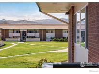 Brick building featuring grass lawn and mountain views at 5120 Williams Fork Trl # 214, Boulder, CO 80301