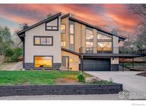 Striking modern home with unique architectural details, professional landscaping and picturesque sunset sky at 1048 Westview Dr, Boulder, CO 80303