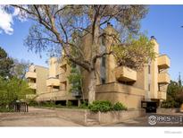 Condo building with striking architecture, enhanced by mature trees, offering a blend of urban living and nature at 2711 Mapleton Ave # 1, Boulder, CO 80304