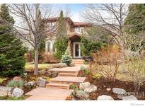 Charming two-story home with a well-maintained front yard and inviting stone pathway at 3151 6Th St, Boulder, CO 80304