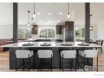 Bright, modern kitchen with quartz countertops and stylish bar stool seating at 4223 Peach Way, Boulder, CO 80301