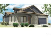Charming single-story home with a stone and gray facade, complemented by a well-manicured lawn and an attached garage at 499 Muirfield Cir, Louisville, CO 80027