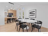 Open-concept dining area featuring modern decor, bright white walls, and contemporary light fixture at 586 Aztec Dr, Boulder, CO 80303