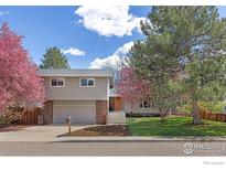 Charming two-story home with manicured lawn, mature trees and an attached two-car garage at 586 Aztec Dr, Boulder, CO 80303