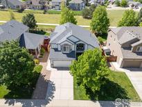 Stunning aerial view of this charming two-story home with a well-manicured lawn in a serene neighborhood at 5912 Thistle Ridge Ave, Firestone, CO 80504